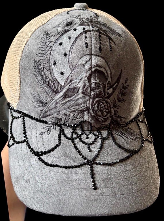 Bling gothic crow, hand-burned Vegan (faux) suede grey with tan mesh ponytail back. Hand attached black rhinestones. Acrylic highlights