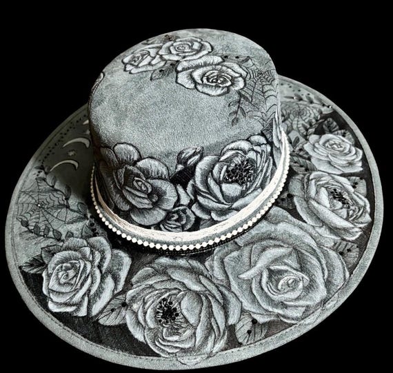 A little gothic, a little whimsy, Hand-Burned hard body Wide Brimmed Hat. Flowers, a bat, the moon phases & spider webs, black rhinestones