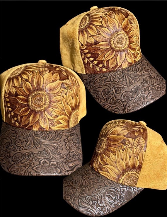 Free-hand, hand-burned sunflowers on Vegan (faux) suede ball cap. Tooled brown faux leather brim