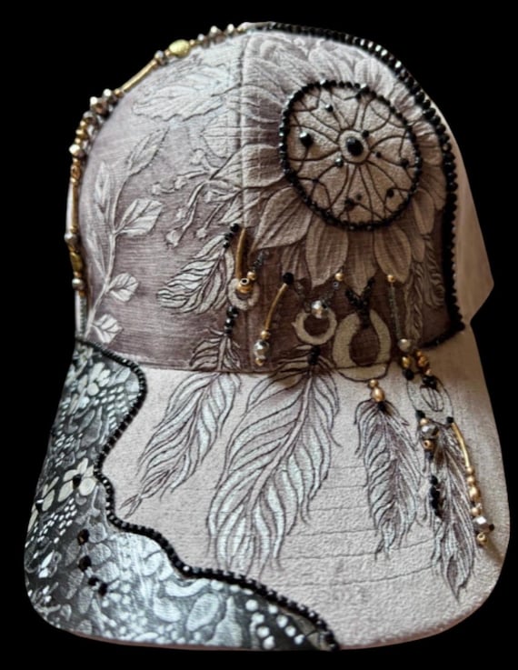 Free-Hand-Burned dream catcher flower, feathers, beads, rhinestones, faux leather. Neutral colors of grey, black, silver, gold, and bronze.