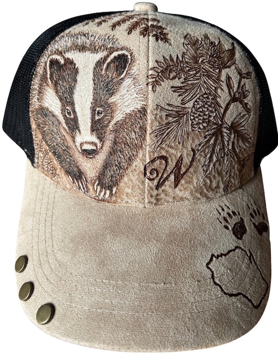 Badger in the woods, hand-burned using a hand held wood burner. Vegan (faux) suede tan with black mesh back. Unique for badger fans!