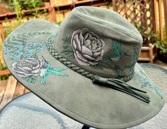 Hand-Burned and painted flowers and hummingbirds, thicket green colored vegan suede floppy wide brim. One size fits most. Wearable Art