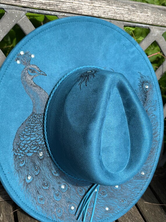 Stunning peacock wide brim hat. Beautifully detailed hand burned into peacock blue vegan suede using a wood burning tool.