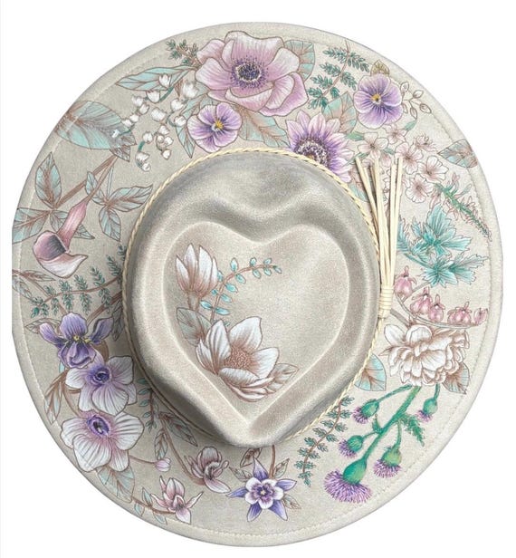Hand-Burned mixed floral, wide brim heart crown hat, Ivory vegan suede. Then hand-painted with permanent water resistant acrylic paint.