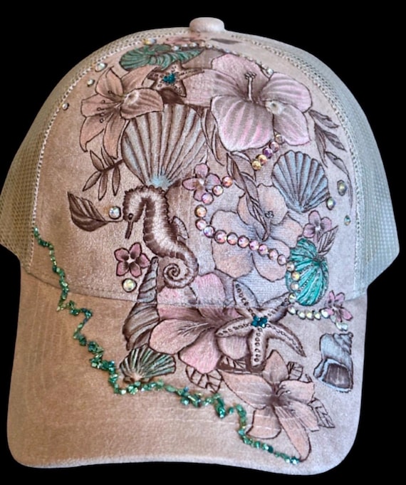 Beach shimmer, sea shells and flowers, hand-burned, hand-painted Vegan (faux) suede mesh back ball cap. Hand attached rhinestones.