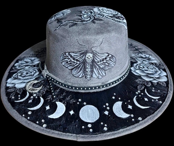 Death’s head moth, moon phases, snake and floral Hand-Burned and hand painted flat top hard body Wide Brimmed Hat. Rhinestones.