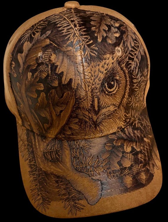 Owl, pine, oak, antler, free-hand, hand-burned using a hand held wood burner. Vegan (faux) suede ball cap with adjustable back sizer.