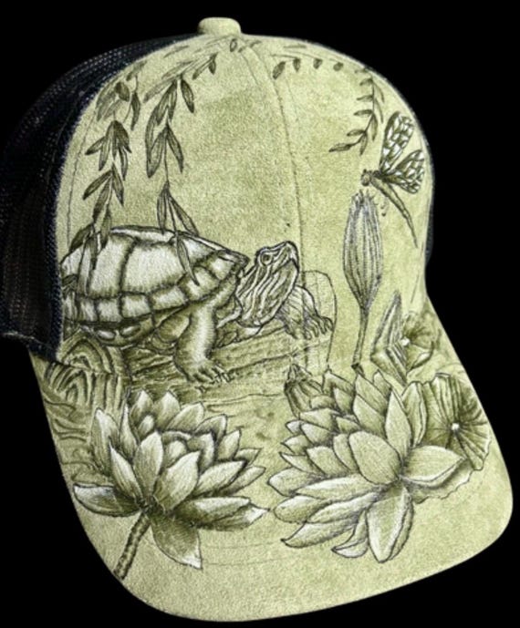 Green turtle lily pad lake scene, hand-burned using a wood burner, on Vegan (faux) suede ball cap. Wearable art!