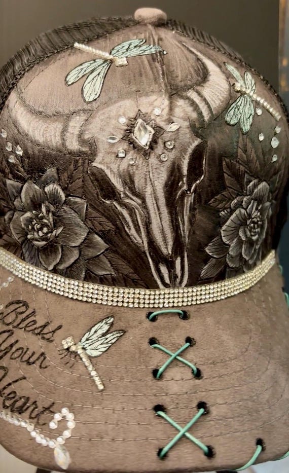 Bless Your Heart, skull & floral trucker hat. Hand-burned using a wood burner. Gray Vegan suede adjustable black mesh back. Wearable art!