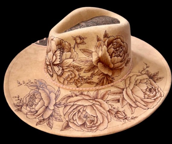 Beautiful peonies! Peonies and butterflies are hand-burned. Tooled brown faux leather and rose gold lacing added to the brim and top.