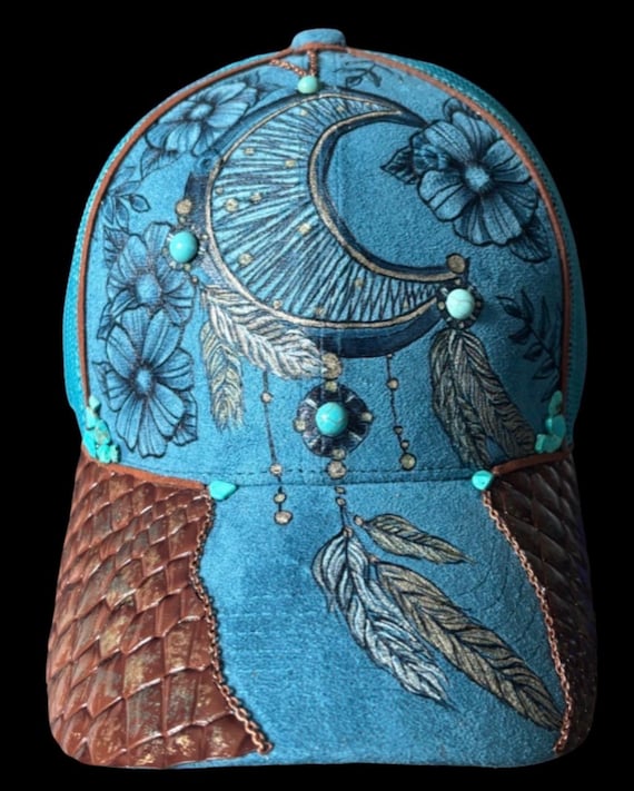 Dream catcher design, hand-burned, teal faux suede ponytail mesh back ball cap.  Bronze, gold, and turquoise accents, faux snake skin.