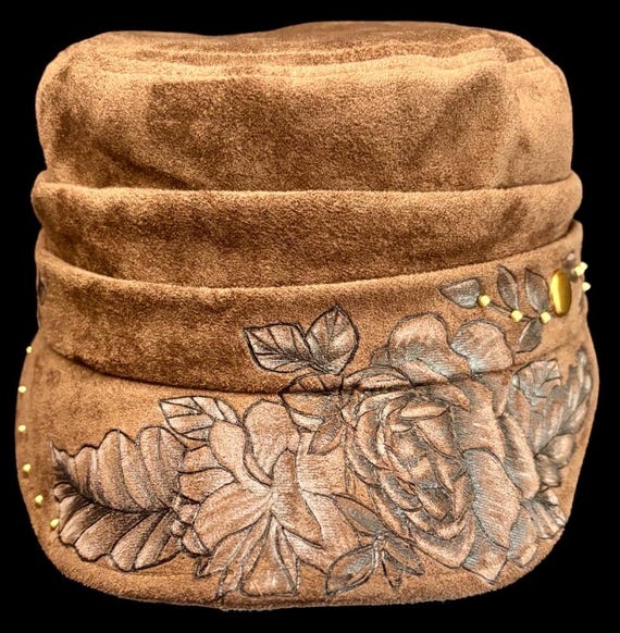 Hand-Burned flowers, newsboy style cap, brown Vegan Suede, slight highlight paint. Bronze studs. One size fits most adults, inner sizer.