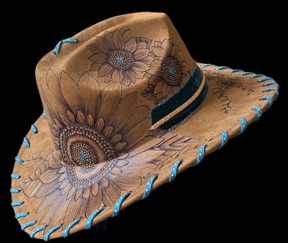 Cowgirl hat, hand-burned sunflower design using a wood burning tool. Exquisite shading, details, teal accents and specialty hat band.