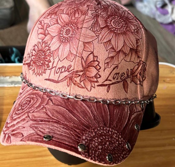 Strength Hope Love, hand-burned floral design, faux suede pink ball cap. Silver chain and rivets.