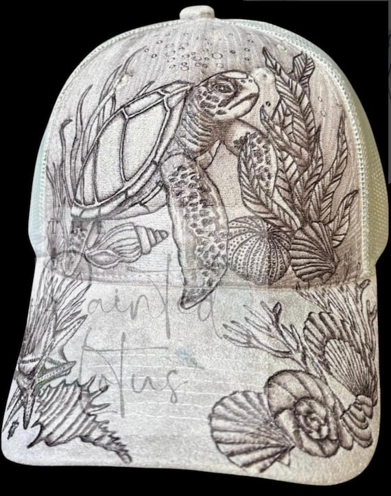 Sea turtle and shells, hand-burned Vegan (faux) suede ball cap. Highly detailed, on a grey mesh ponytail back cap.