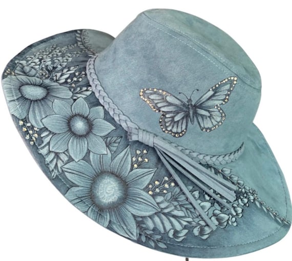 Hand-Burned flowers and butterflies, light blue/denim blue colored vegan suede floppy wide brim. Rhinestones attached by hand. Wearable Art