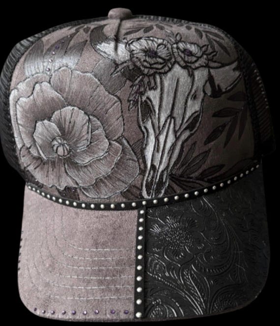 Hand-Burned gray trucker hat, black mesh snap back. Floral w/steer skull. Can add personalized wording.