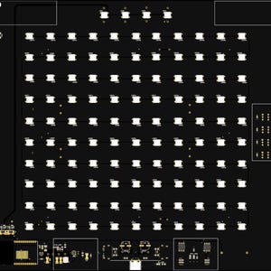 May include: A black printed circuit board featuring a grid of white square LED components arranged in rows and columns. The board includes integrated circuitry, a micro-USB port at the bottom center, and various electronic surface-mount components.