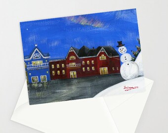 Hilly Hope Village - Folk Art Winter Christmas Card with a Snowman, frozen pond, winter village, full moon, Northern Lights, aurora borealis