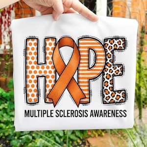 May include: White t-shirt with the word "HOPE" in orange and black. The "H" has orange polka dots, the "P" has orange stripes, and the "E" has a leopard print design. An orange ribbon is in the center. The text "MULTIPLE SCLEROSIS AWARENESS" is below.
