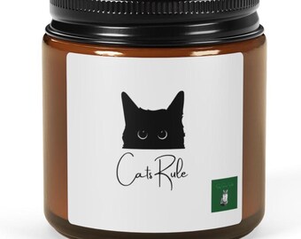 May include: A brown glass jar with a black lid. The jar has a white label with a black cat silhouette and the words "Cats Rule" in cursive. A small green square with a cat illustration is on the label.