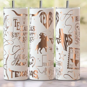 May include: White stainless steel tumbler with copper-coloured Texas-themed graphics, including a longhorn, cowboy, and state outline. Text includes "Texas is my happy place" and "Y'all". The tumbler has a silver straw.