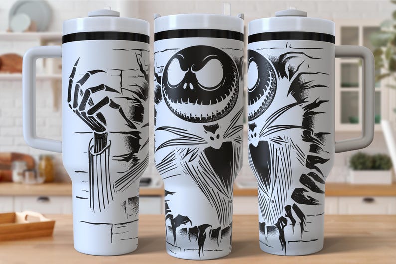 May include: White travel mug with a black and white illustration of Jack Skellington from The Nightmare Before Christmas. The design wraps around the mug, featuring a skeleton hand, Jack's face, and other spooky elements. The mug has a white handle and lid.