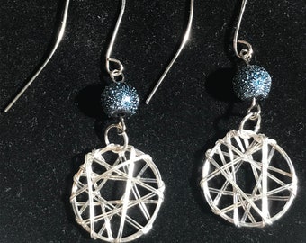 Dream catcher wire wrap earring with a textured blue bead