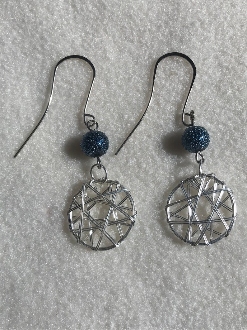 Dream catcher wire wrap earring with a textured blue bead