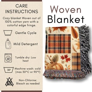 May include: Woven blanket with a fall theme. The blanket features a patchwork design with pumpkins, leaves, and plaid patterns in shades of orange, brown, and cream. It has a colorful fringe and care instructions.