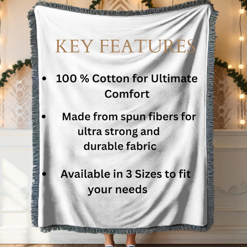 May include: A white woven blanket with a gray fringe. The blanket features the text "KEY FEATURES" and bullet points highlighting its 100% cotton composition, spun fiber construction, and availability in three sizes.