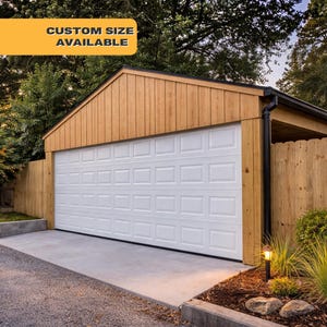 May include: A white garage door with a grid pattern is the focal point of this image. The garage is part of a wooden structure with a brown roof and siding. The text "CUSTOM SIZE AVAILABLE" is displayed on a yellow banner. A concrete driveway leads up to the garage.