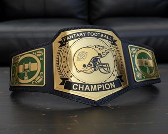 May include: A gold and black Fantasy Football Champion belt. The belt features a gold centre plate with a football helmet design and the words "Fantasy Football Champion". The side plates have football and field goal post designs.