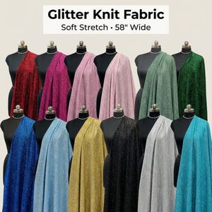 May include: A variety of glitter knit fabric swatches in various colors, draped over mannequins. The fabric colors include red, pink, light pink, green, dark green, blue, light blue, gold, black, silver, and teal. The text at the top reads "Glitter Knit Fabric, Soft Stretch, 58" Wide."