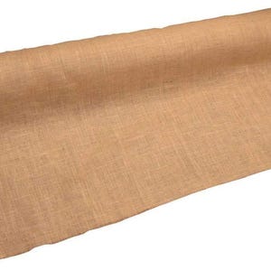 May include: A roll of natural-colored burlap fabric. The fabric is a light brown with a visible woven texture. The roll is partially unrolled, revealing the fabric's width and texture. Ideal for crafts and rustic decor.