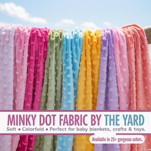 May include: A display of colorful minky dot fabric in various shades, including pink, green, blue, and yellow. The fabric is soft and textured, with a dot pattern. Text on the image reads "MINKY DOT FABRIC BY THE YARD".