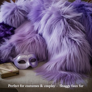 May include: A display of fluffy, long-pile faux fur in shades of purple. A decorative mask and a small, antique-style box are placed on a neutral surface. The text at the bottom reads "Perfect for costumes & cosplay - Shaggy fuux fur."