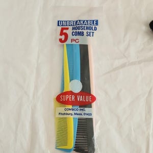 May include: A package of five plastic combs in various colors: yellow, blue, black, and pink. The package reads "UNBREAKABLE HOUSEHOLD COMB SET" and "SUPER VALUE". The combs are made by COMBCO INC.