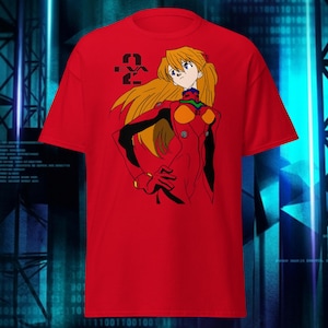 May include: Red t-shirt featuring a graphic of an anime character in a red and black suit with long blonde hair. The number "2" is printed in black on the upper left. The shirt is made of a soft material.