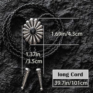May include: A black bolo tie with a silver-colored, flower-shaped pendant featuring a black center stone. The pendant measures 1.69 inches (4.3 cm) in diameter. The braided cord is 39.7 inches (101 cm) long, with decorative silver tips.