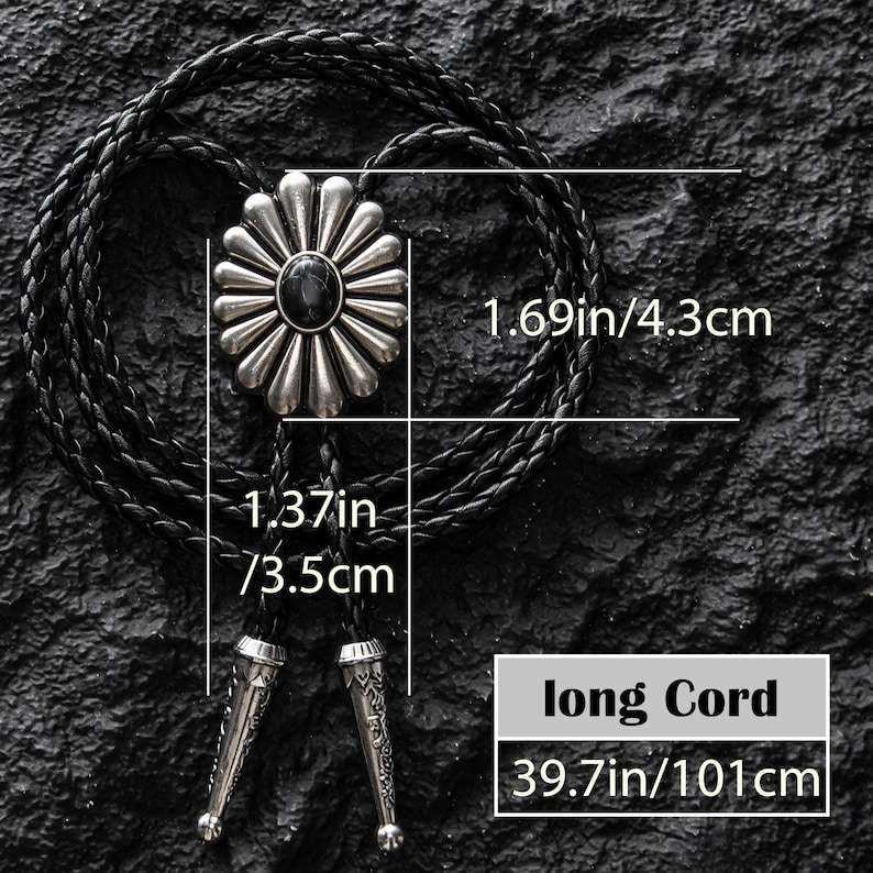 May include: A black bolo tie with a silver-colored, flower-shaped pendant featuring a black center stone. The pendant measures 1.69 inches (4.3 cm) in diameter. The braided cord is 39.7 inches (101 cm) long, with decorative silver tips.