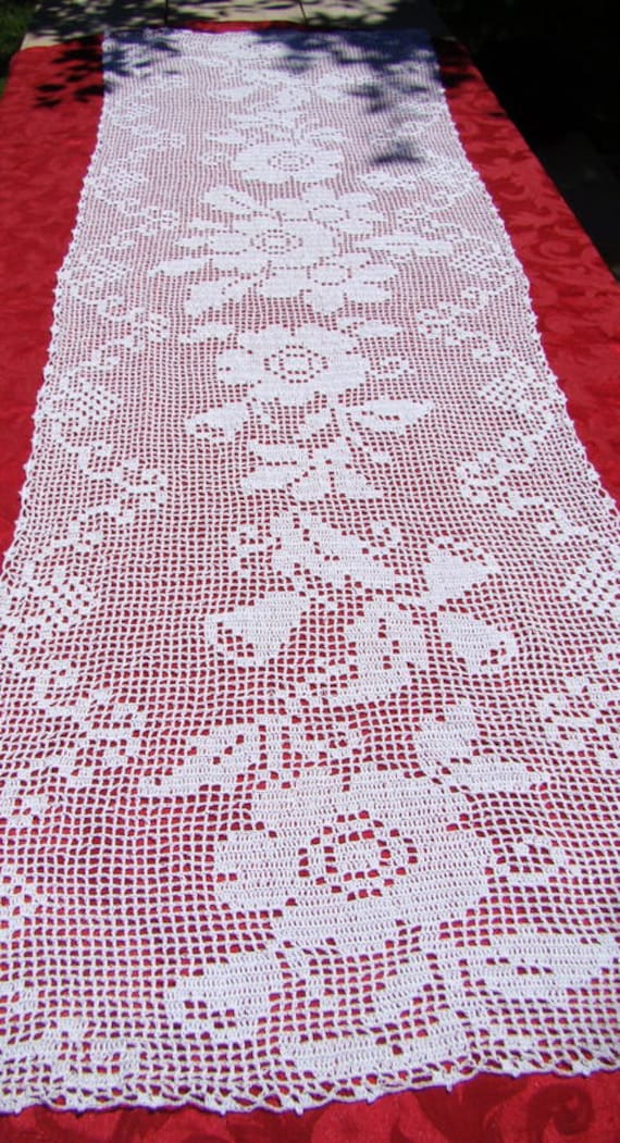 White filet crocheted table runner with primroses and bluebells