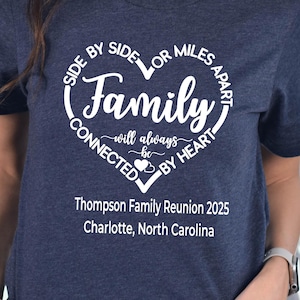 May include: Navy blue t-shirt with a white heart-shaped graphic that reads "Family will always be connected by heart." Below the graphic is "Thompson Family Reunion 2025, Charlotte, North Carolina."