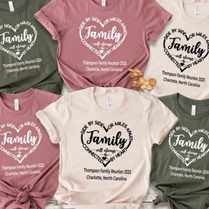 May include: Six short-sleeved crew neck t-shirts in olive green, dusty rose, and cream. Each shirt features a heart-shaped graphic with the text: Side by side or miles apart, Family will always be connected by heart, Thompson Family Reunion 2025, Charlotte, North Carolina.