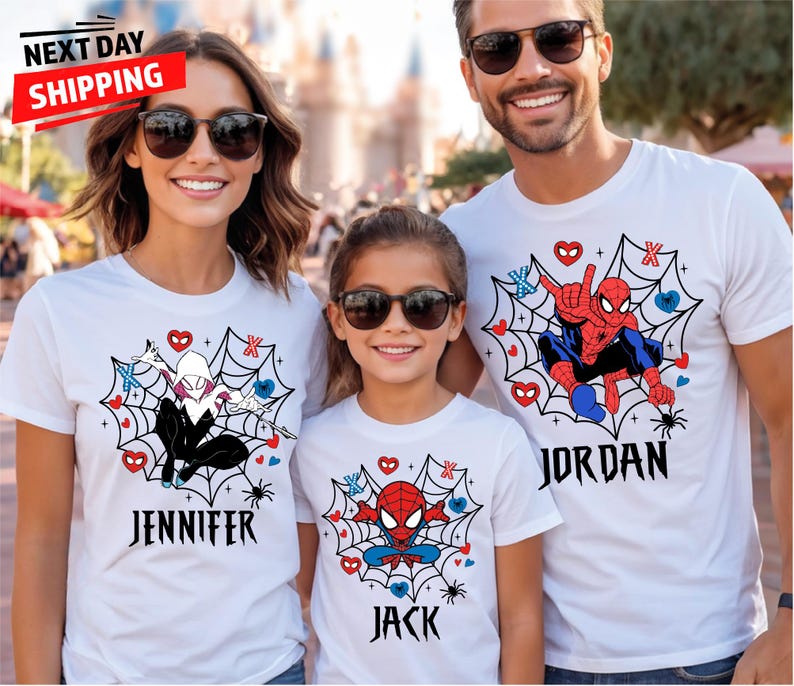 May include: Three people wearing white t-shirts with superhero designs. The shirts feature Spider-Man and Spider-Gwen graphics within a spiderweb design, with names printed below. The image includes the text "NEXT DAY SHIPPING".