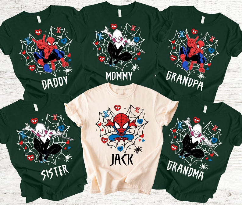May include: A selection of green and cream t-shirts with Spider-Man and Spider-Gwen graphics. Each shirt is labelled with a family member's name: Daddy, Mommy, Grandpa, Grandma, Sister, and Jack. The designs incorporate spiderwebs, hearts, and spider illustrations.