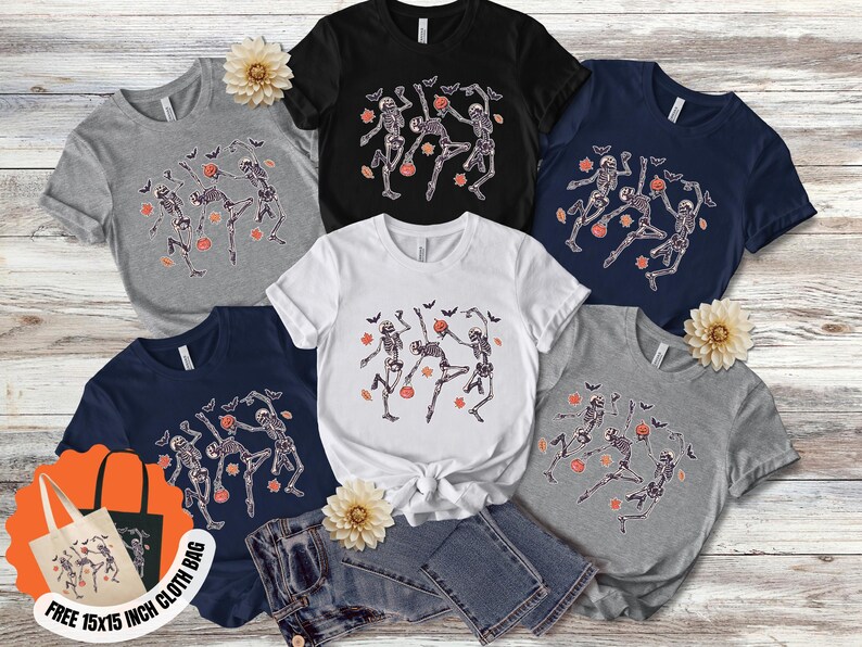 May include: Selection of t-shirts in grey, black, white, and navy blue, each displaying a dancing skeleton design with bats and pumpkins. Includes a free 38x38 cm cloth bag.