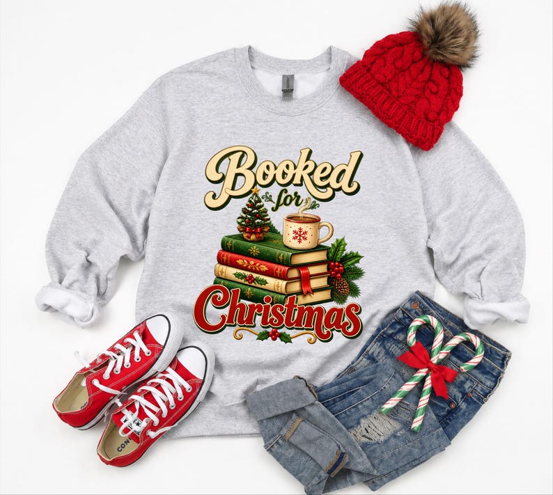 A gray sweatshirt with a graphic design, a red knit hat, red and white sneakers, a pair of blue jeans, and a pair of red and white candy canes.