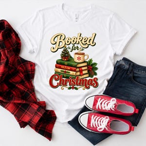 A white t-shirt with a graphic design, a red and black plaid shirt, a pair of red and white sneakers, and a pair of blue jeans, all laid out on a white background.