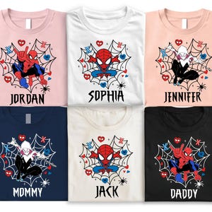 May include: Six t-shirts in different colours, each with a Spider-Man graphic within a web design. The shirts are personalised with names such as "Jordan," "Sophia," and "Jennifer." The designs include hearts and spider illustrations.